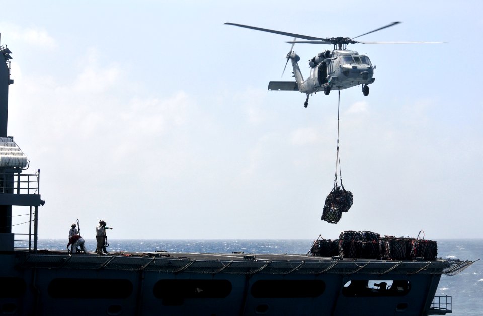 US Navy 120103-N-ZI635-691 A helicopter retrieves supplies