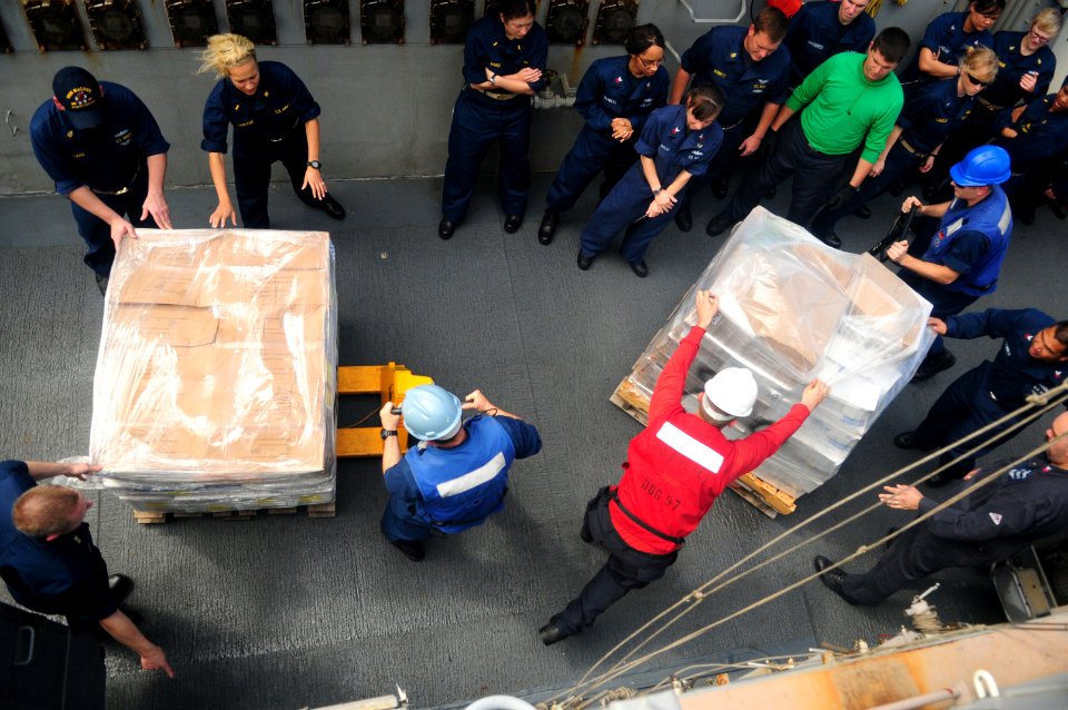 US Navy 120102-N-ZF681-313 Sailors aboard the guided-missile destroyer USS Halsey (DDG 97) move pallets of supplies during a replenishment at sea w