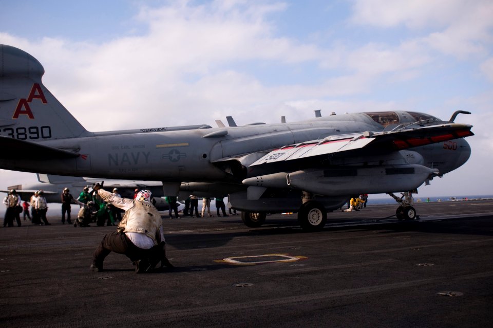 US Navy 111231-N-TZ605-038 Sailors assigned to Electronic Attack Squadron (VAQ) 134 act as final checkers before launching an EA-6B Prowler off the