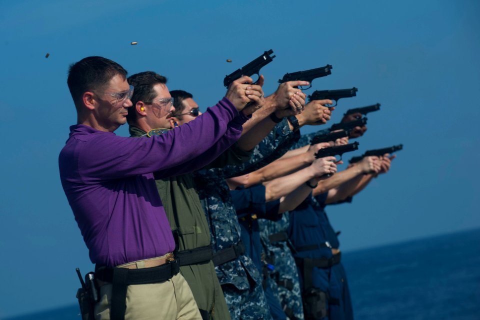 US Navy 111229-N-PB383-675 Sailors fire at their targets during a 9mm live-fire exercise aboard the amphibious transport dock ship USS New Orleans