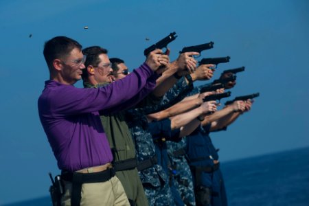 US Navy 111229-N-PB383-675 Sailors fire at their targets during a 9mm live-fire exercise aboard the amphibious transport dock ship USS New Orleans photo