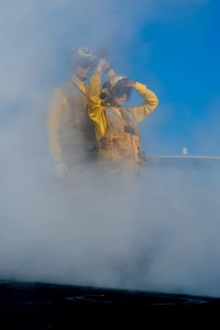 US Navy 120101-N-OY799-139 Aviation Boatswain's Mate (Handling) 3rd Class Taylor Maxwell, right, directs a fixed wing aircraft onto catapult four o