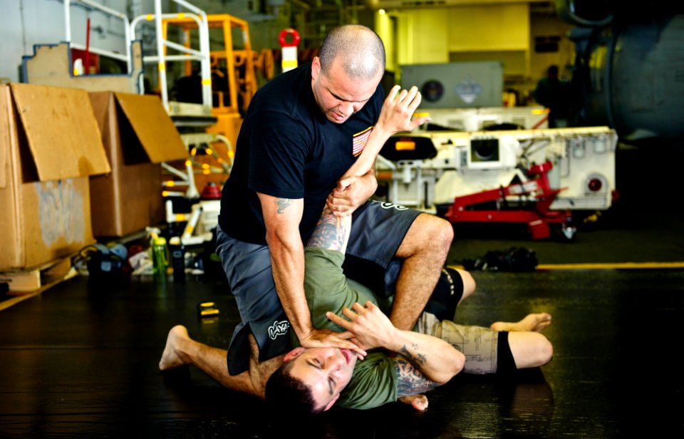 US Navy 120102-N-GC412-128 Sailors practice mixed martial arts in the hangar bay