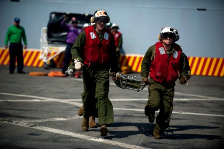 US Navy 120103-N-PB383-464 Marines assigned to the 11th Marine Expeditionary Unit (11th MEU) carry a stretcher during a flight deck firefighting ex