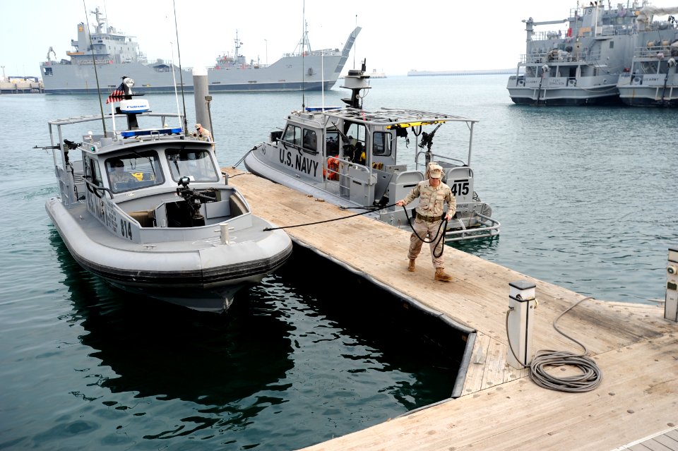 US Navy 120107-N-RP435-486 Boatswain's Mate 3rd Class Moulton LeBlanc moors a U.S. Navy coastal patrol boat after a patrol of Kuwait Naval Base's h