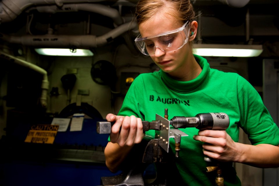 US Navy 120102-N-RJ456-017 A Sailor puts rivets into testing material