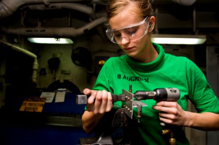 US Navy 120102-N-RJ456-017 A Sailor puts rivets into testing material