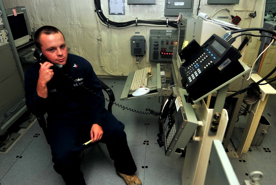 US Navy 120101-N-CT127-061 Boatswain's Mate 3rd Class Adam Tabor wishes Secretary of Defense Leon Panetta a happy New Year aboard the San Antonio