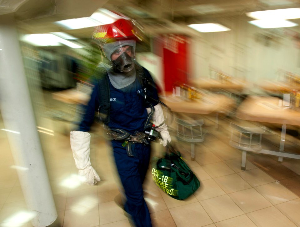 US Navy 120109-N-DR144-170 Gas Free Engineer Damage Controlman 2nd Class William Beck responds to a simulated fire