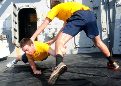 US Navy 120105-N-ZF681-229 Sailors aboard the guided-missile destroyer USS Halsey (DDG 97) practice takedown techniques during crowd control tactic
