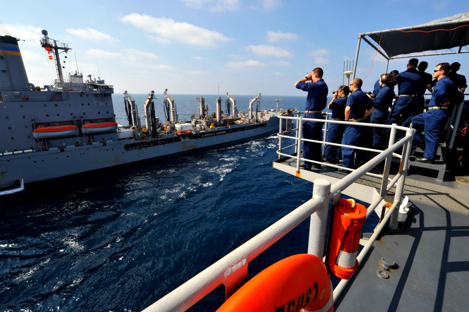 US Navy 120104-N-KS651-067 Sailors stand watch on the bridge wing of amphibious dock landing ship USS Pearl Harbor (LSD 52) during a replenishment
