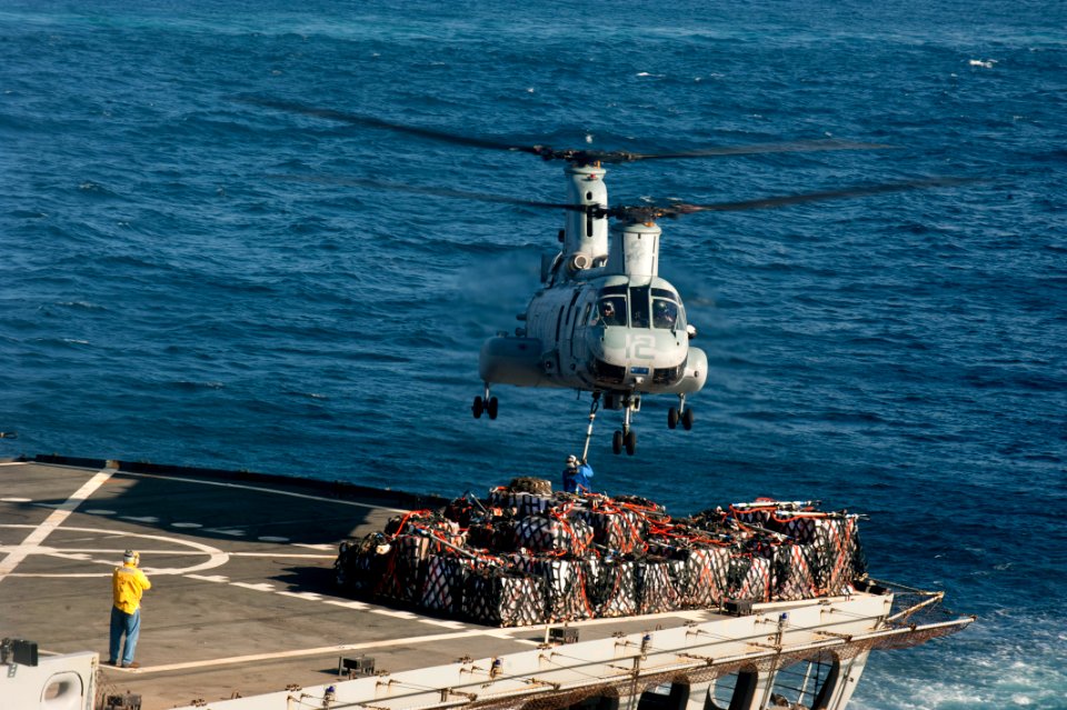 US Navy 120104-N-PB383-021 A helicopter transfers cargo between ships