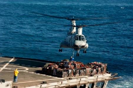 US Navy 120104-N-PB383-021 A helicopter transfers cargo between ships