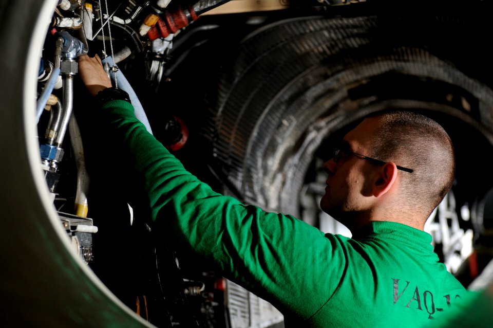 US Navy 120108-N-RG587-101 Aviation Structural Mechanic Airman Ryan Hollifield, assigned to Electronic Attack Squadron (VAQ) 134, cleans the engine
