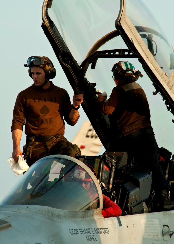 US Navy 120105-N-BT887-108 Sailors clean the canopy of an F-A-18F Super Hornet from the Black Aces of Strike Fighter Squadron (VFA) 41 aboard the N