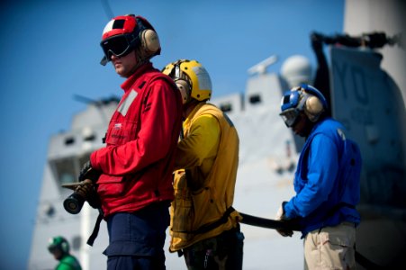 US Navy 120103-N-PB383-516 Aviation Ordnanceman 2nd Class Michael Beebe mans a fire hose during a flight deck firefighting exercise aboard the amph