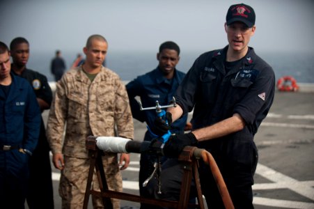 US Navy 120105-N-PB383-055 A Sailor demonstrates how to properly patch a pipe during a damage control training exercise