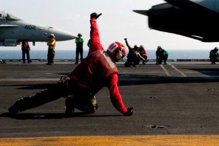 US Navy 120110-N-OY799-332 Aviation Ordnanceman 2nd Class Jason Ortiz signals safe to launch for an F-A-18C Hornet from Golden Dragons of Strike Fi