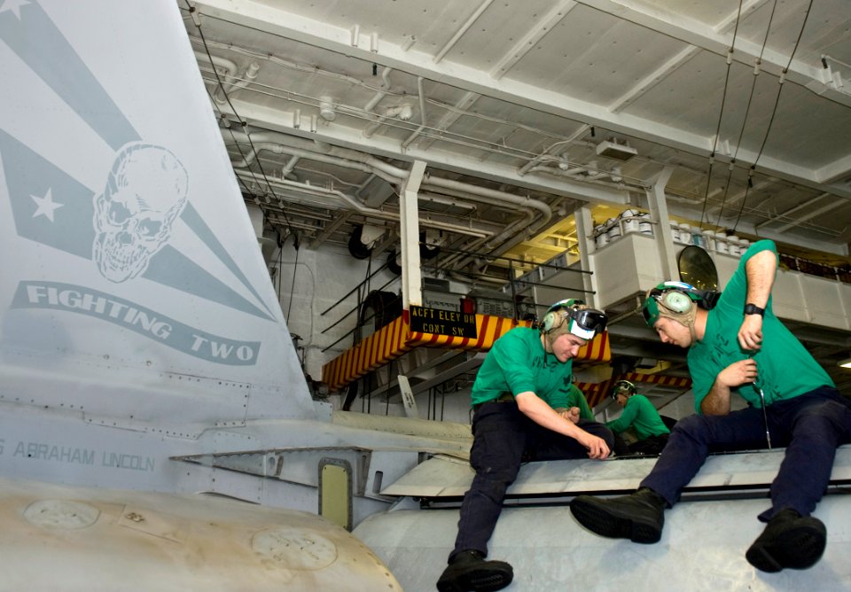 US Navy 120111-N-VO377-010 Sailors perform maintenance on an F-A-18F Super Hornet