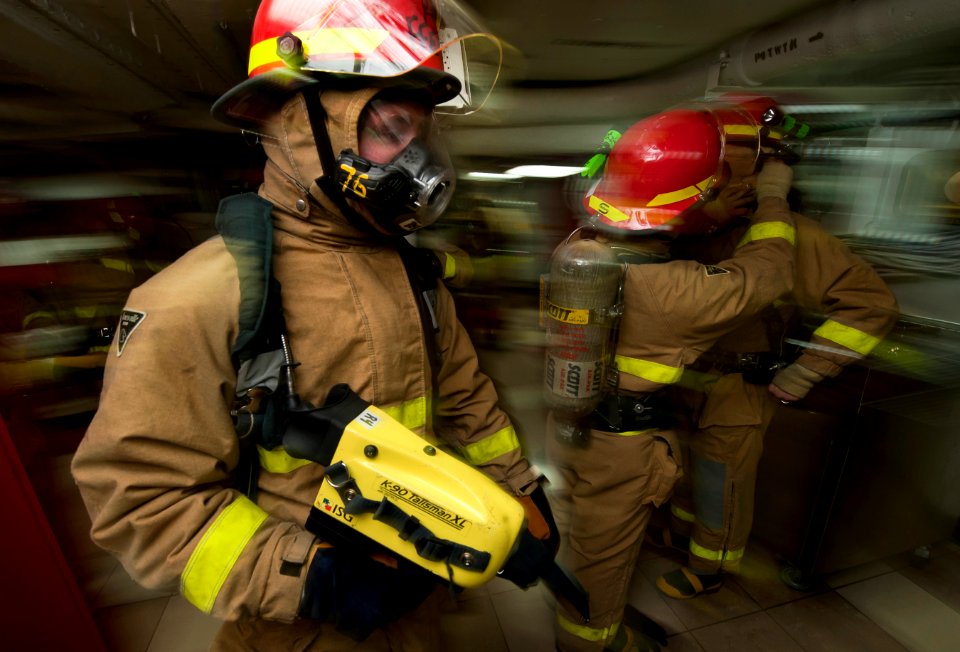 US Navy 120106-N-DR144-069 Damage Controlman 2nd Class Jared Olah, a member of the ship's flying squad, prepares to lead a hose team as they respon