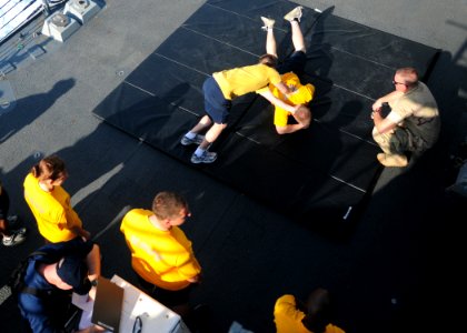 US Navy 120105-N-ZF681-115 Sailors aboard the guided-missile destroyer USS Halsey (DDG 97) practice takedown techniques during crowd control tactic