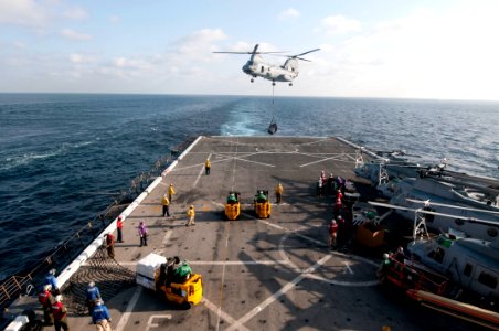 US Navy 120104-N-PB383-536 A helicopter transfers cargo between ships
