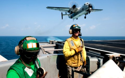 US Navy 120109-N-OY799-185 Sailors observe as an C-2A Greyhound from the Providers of Fleet Logistics Combat Squadron (VRC) 30 lands on the flight