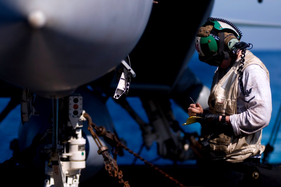 US Navy 120107-N-TZ605-180 Aviation Structural Mechanic 3rd Class Jay Jordan, assigned to Strike Fighter Squadron (VFA) 81, performs a startup chec