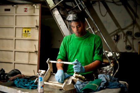 US Navy 120112-N-BT887-271 Aviation Support Equipment Technician Airman Devon Bryant, from Norfolk, cleans support equipment aboard the Nimitz-clas