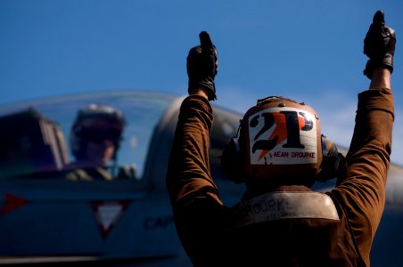 US Navy 120107-N-TZ605-223 Aviation Electrician's Mate Airman Seth Orourke, a plane captain assigned to Strike Fighter Squadron (VFA) 81, signals