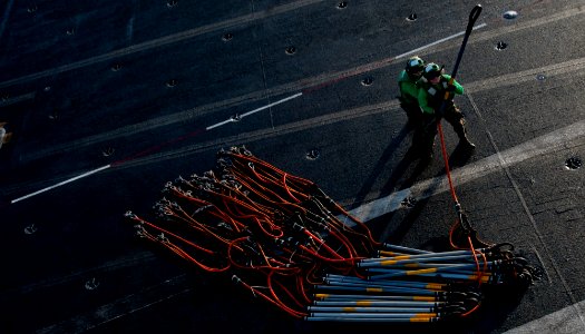 US Navy 120105-N-OY799-020 Logistics Specialist Seamen stand by to hook cargo nets to an MH-60S Knight Hawk helicopter from the Eightballers of Hel