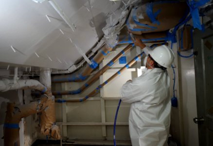 US Navy 120202-N-PO203-114 A Contractor applies an acoustic treatment system aboard USS Dwight D. Eisenhower