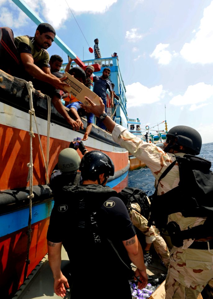 US Navy 120118-N-VH839-032 Sailors from the guided-missile destroyer USS Dewey's (DDG 105) visit, board, search and seizure team provide food, wate