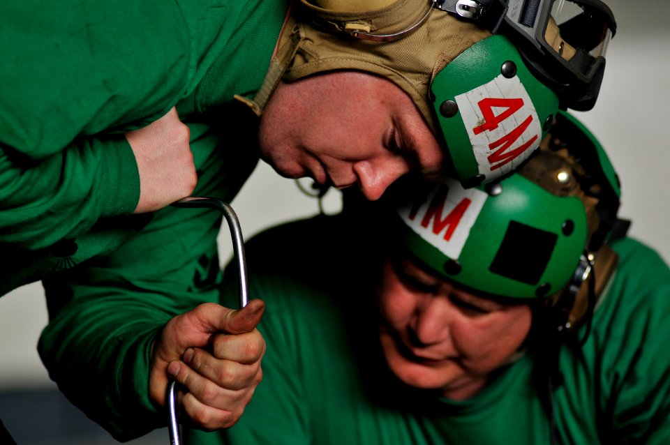 US Navy 120111-N-ZI635-112 Aviation Structural Mechanics 1st Class Keneth L. Favors, left, and Christopher D. Weems, both assigned to Strike Fight