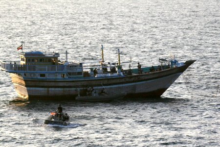US Navy 120105-N-ZZ999-001 A Sailor aboard a safety boat observes a visit, board, search and seizure team, assigned to the guided-missile destroyer