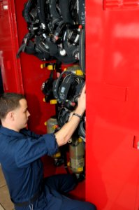 US Navy 120109-N-GZ832-204 Damage Controlman Fireman Cameron Michalak inspects self-contained breathing apparatuses