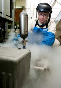 US Navy 120109-N-OY799-261 Machinist's Mate 2nd Class John Burge, from Alpharetta, Ga., collects liquid oxygen samples in the forward O2N2 plant ab