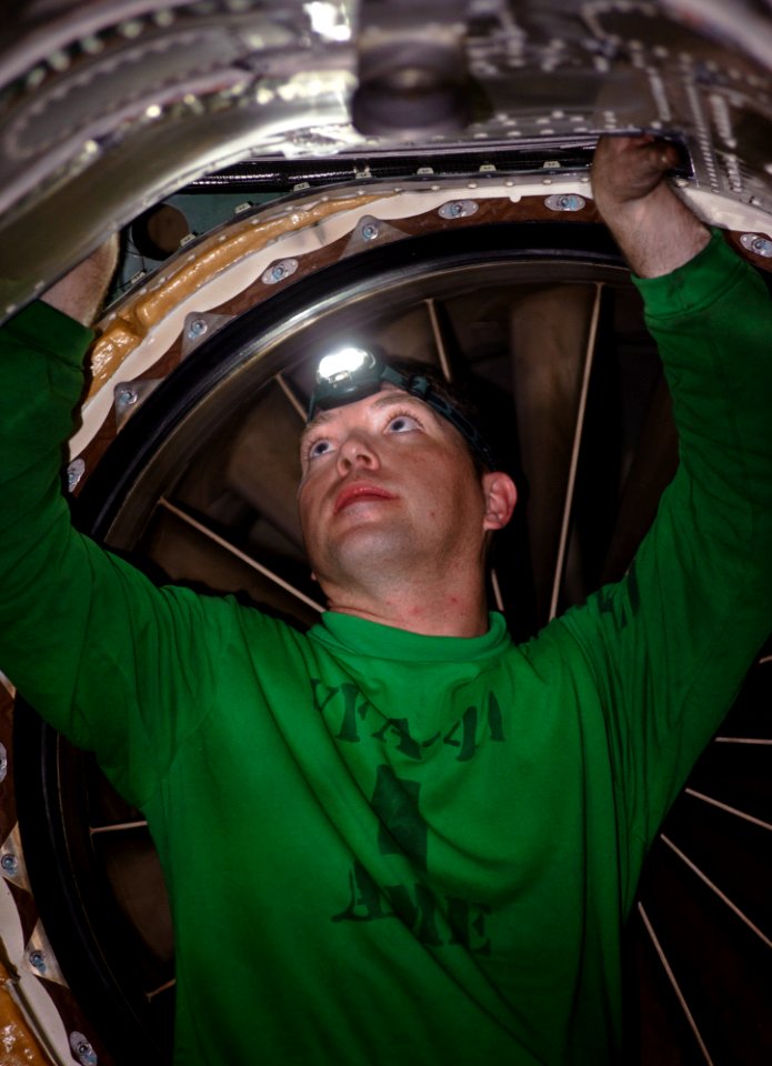 US Navy 120110-N-GC412-027 Aviation Structural Mechanic (Equipment) 2nd Class Timothy Jones performs maintenance on an F-A-18F Super Hornet