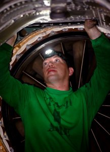 US Navy 120110-N-GC412-027 Aviation Structural Mechanic (Equipment) 2nd Class Timothy Jones performs maintenance on an F-A-18F Super Hornet