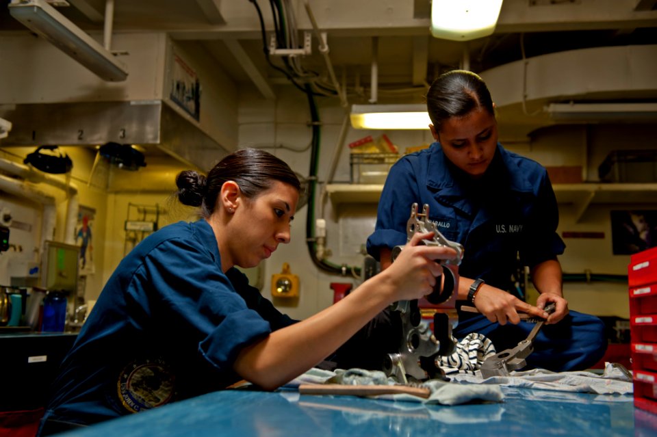 US Navy 120112-N-BT887-235 Sailors clean the housing of a BRU-32 aboard the Nimitz-class aircraft carrier USS John C. Stennis (CVN 74)