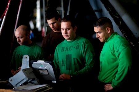US Navy 120110-N-BT887-177 Aviation Machinist's Mate 1st Class Joseph Clifford, from Rockford, Ill., researches maintenance steps for an MH-60S Sea