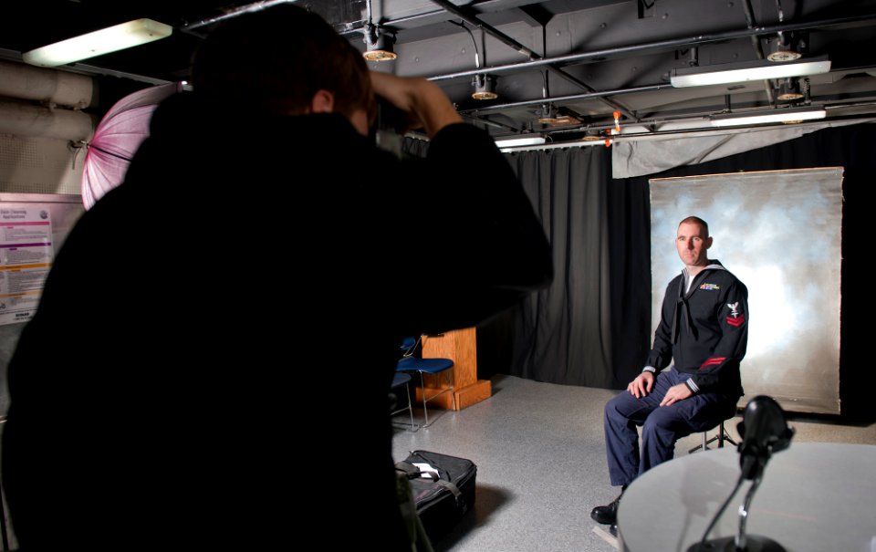 US Navy 120112-N-OY799-085 Hospital Corpsman 2nd Class Brian Grass, from Waunakee, Wisc., gets his cruisebook photo taken in the TV studio aboard t