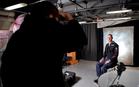 US Navy 120112-N-OY799-085 Hospital Corpsman 2nd Class Brian Grass, from Waunakee, Wisc., gets his cruisebook photo taken in the TV studio aboard t