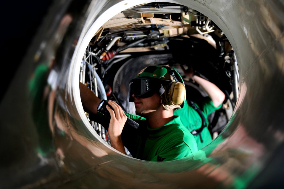 US Navy 120108-N-RG587-066 Aviation Electrician's Mate 3rd Class Charles Follet, assigned to Electronic Attack Squadron (VAQ) 134, cleans the engin