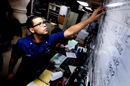 US Navy 120112-N-MD252-101 Aviation Maintenance Administrationman 2nd Class Nicholas Minor, updates a jet engine status board in production control