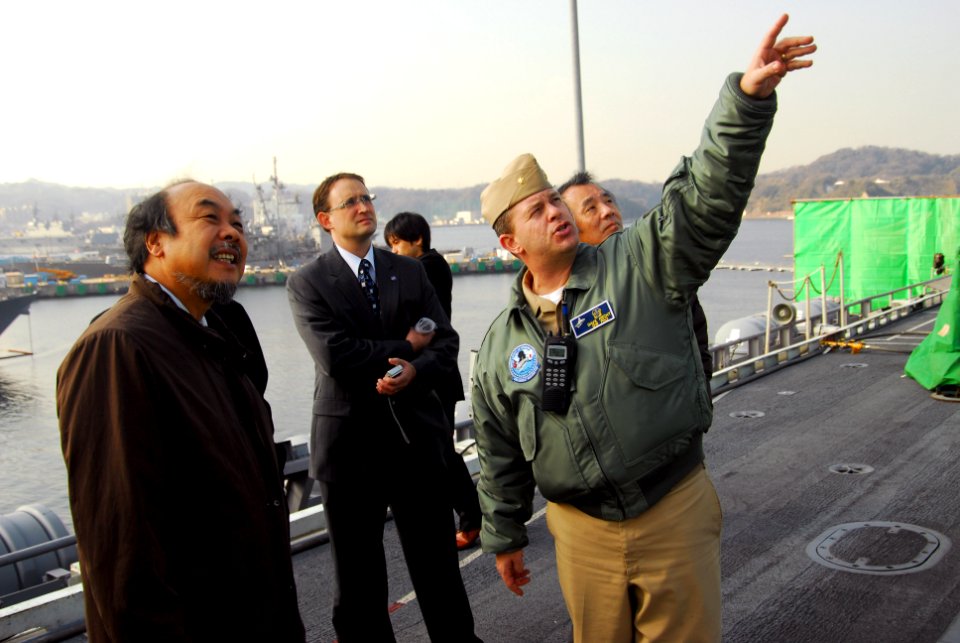 US Navy 120111-N-KM939-085 Lt. Cmdr. Dave Hecht, right, public affairs officer aboard the aircraft carrier USS George Washington (CVN 73), gives vi