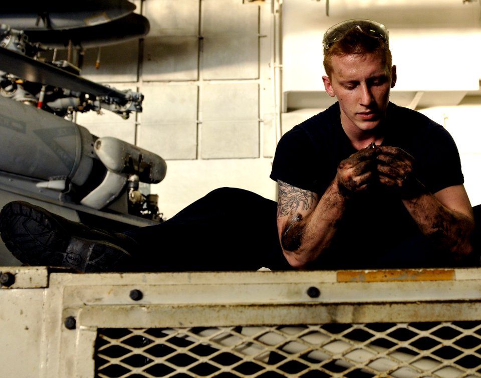 US Navy 120112-N-ZZ999-125 Aviation Support Equipment Technician Airman James Mains performs maintenance on a spotting dolly