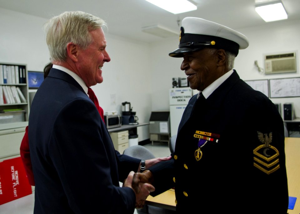 US Navy 120117-N-AC887-446 Secretary of the Navy (SECNAV) the honorable Ray Mabus greets retired Chief Petty Officer Carl E. Clark before presentin