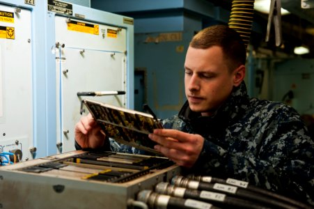 US Navy 120112-N-BT887-190 Aviation Electronics Technician Airman Michael Minten, from Little Chute, Wis., performs maintenance on a roll, pitch, a