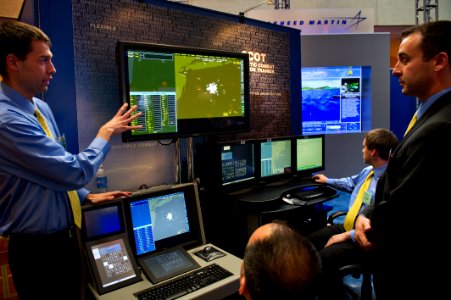 US Navy 120110-N-MG658-064 Francis McFadden, an employee for Lockheed Martin, discusses technology with a visitor during the 24th Annual Surface Na
